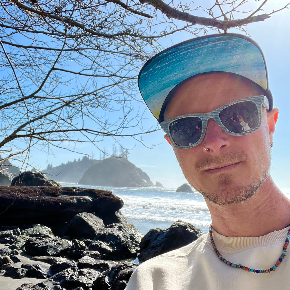 Male model wearing the Atlantis Trucker Hat, showcasing its adventure-ready fit and lightweight feel.