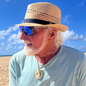 Male model styling the Charlie Fedora, showcasing eco-friendly fedora with black band and coconut button.