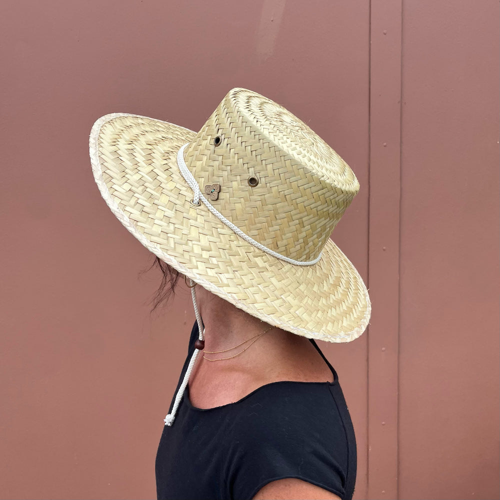 Female model back side view wearing Cordoba Palm Straw Sun Hat, showcasing sun protection and stylish natural straw.