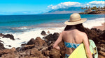 Female model wearing Hana Palm Straw Sun Hat, showcasing wide brim and eco-friendly materials.