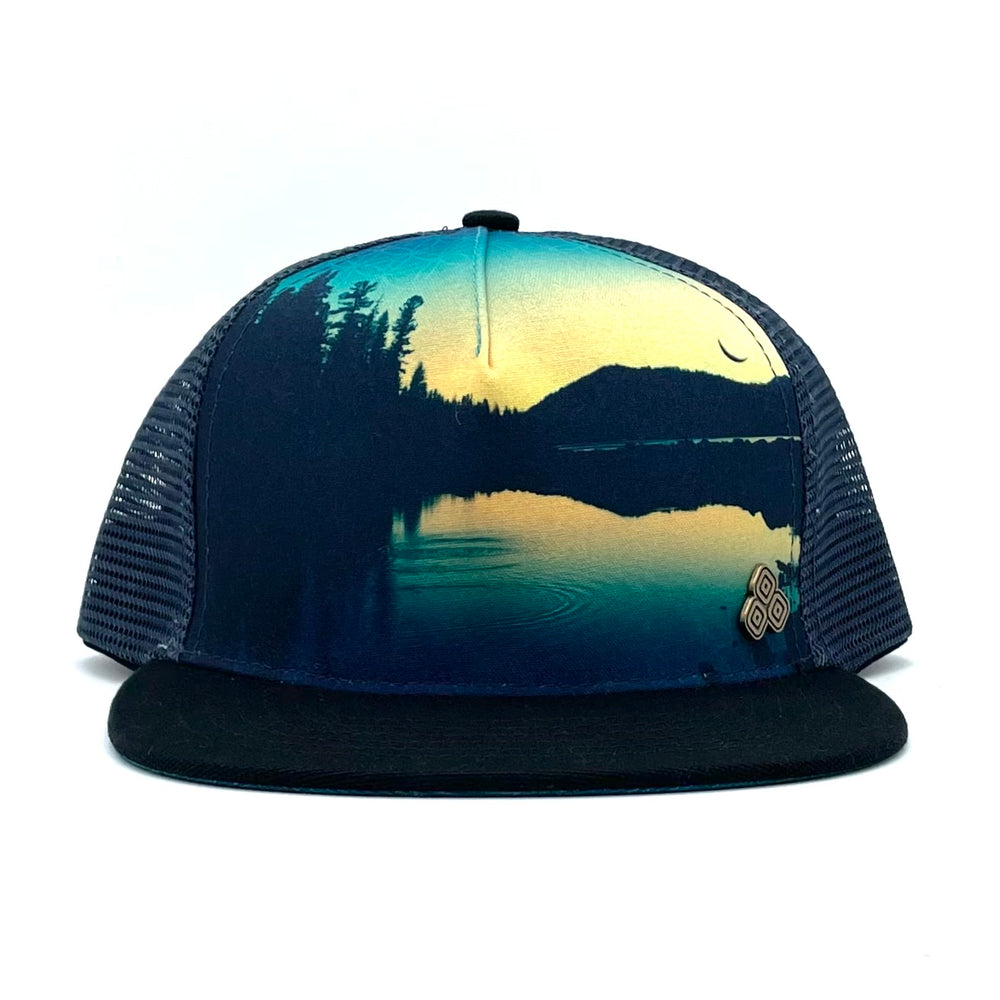 Front view of the Horizon Juniper Trucker Hat featuring Juniper Lake mirrored graphic print, breathable mesh, and adjustable snapback.