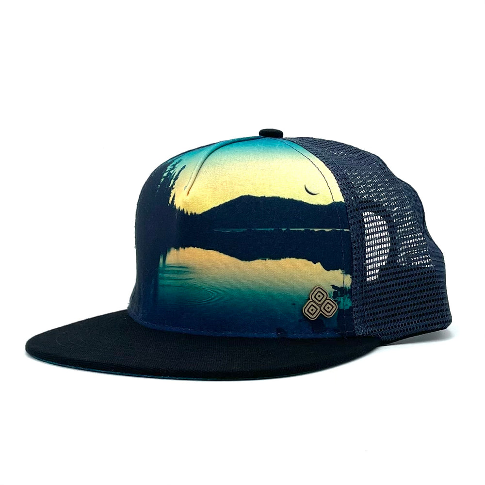 Side profile of the Horizon Juniper Trucker Hat with Lassen National Park-inspired design, mesh back, and structured fit.