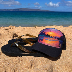 Beach view styling the Horizon Trinidad Trucker Hat, featuring bold artwork, mesh back, and casual outdoor look.