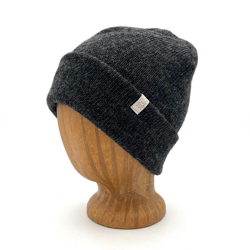 Midnight Beanie in Black color – worn on wooden head block.