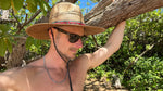 Male model styling Sundaze Palm Straw Sun Hat, demonstrating unisex natural sun hat.