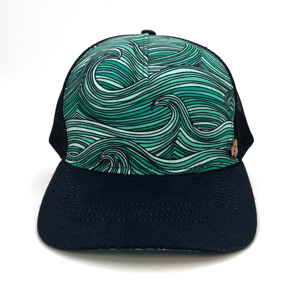 Front view of the Waves Trucker Hat with ocean wave print, breathable mesh back, and adjustable snap closure.