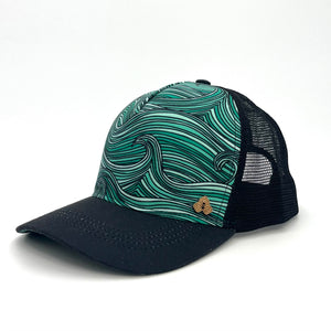 Side profile of the Waves Trucker Hat featuring eco-friendly materials, mesh back, and flat brim.