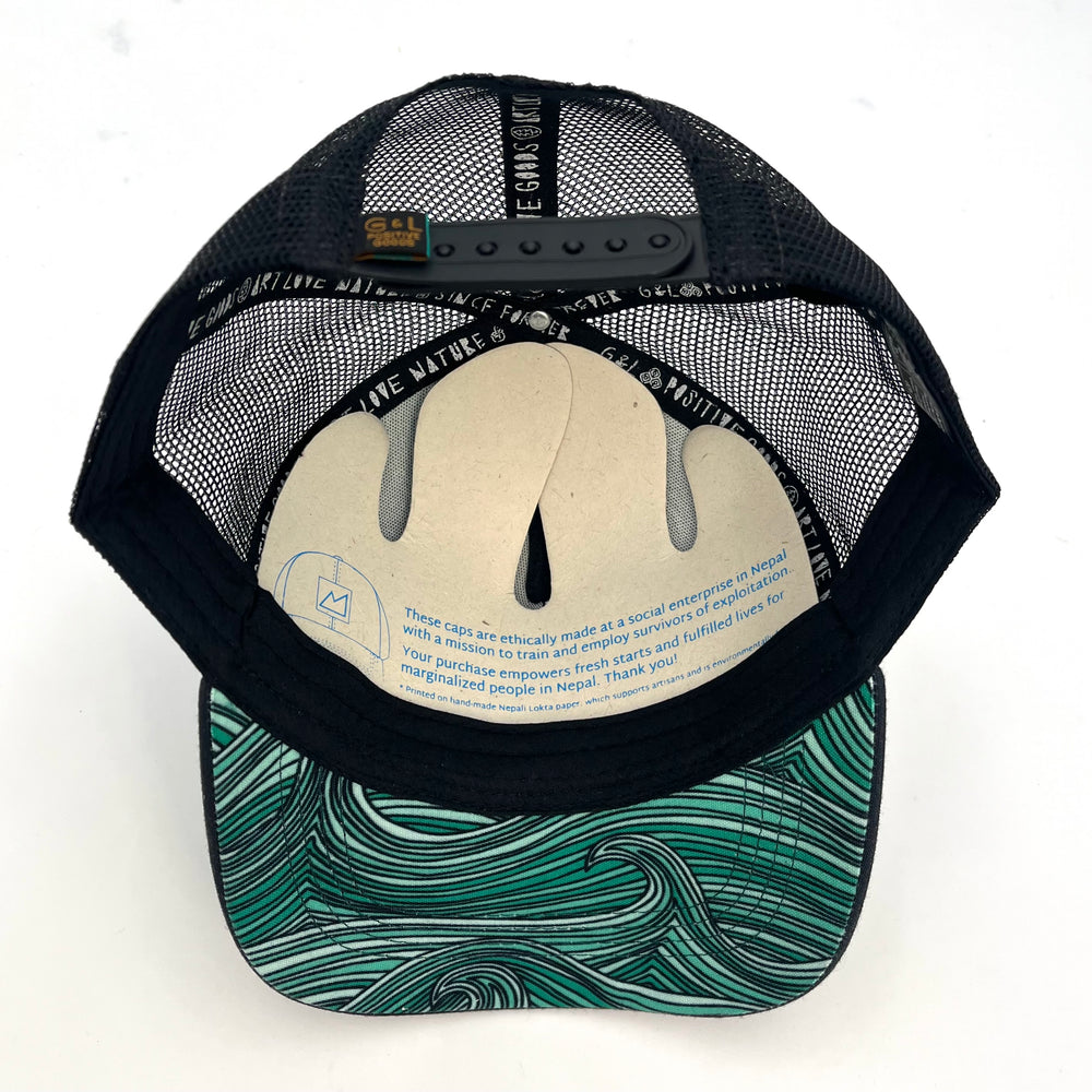 Underside view of the Waves Trucker Hat, showing its durable construction, soft interior, and flat brim.